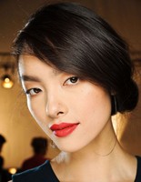 Asian girl updo with low side chignon and long swept bangs