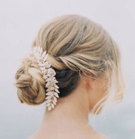 Classic bridal updo with low knot with large floral and leaves hairclips