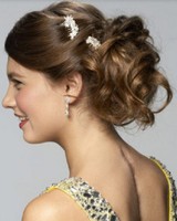 Curly prom low hairdo with curls and pretty white floral hairclips